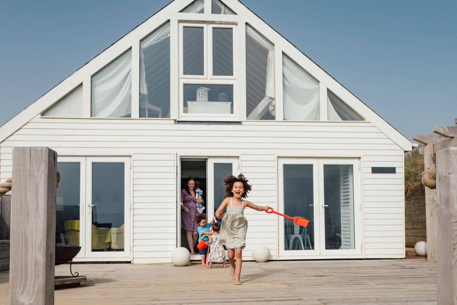 beach house with kids running towards the beach